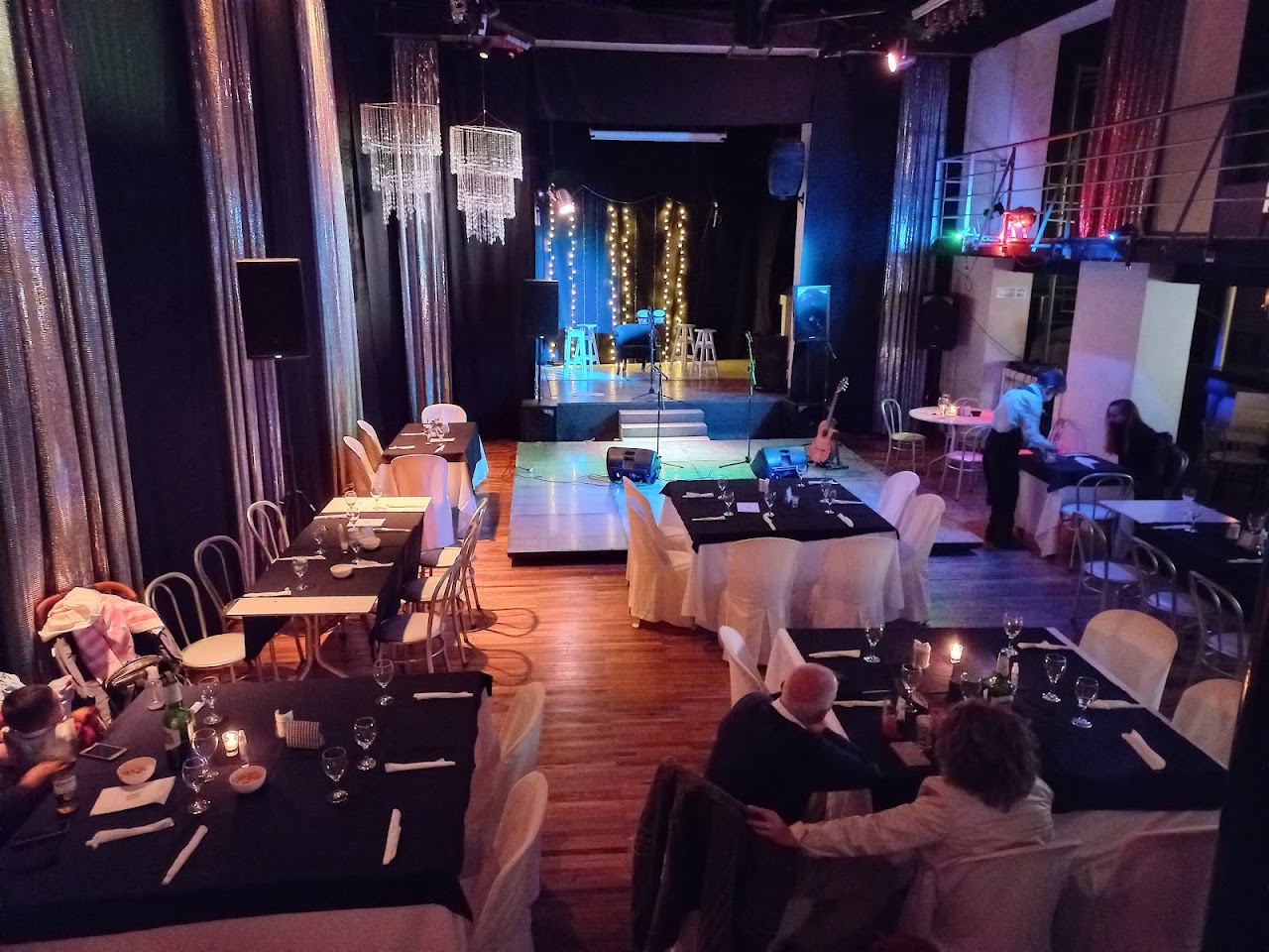 Salón principal de Metrópolis con escenario, luces y mesas montadas para un evento en vivo